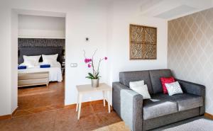 a living room with a couch and a bed at Barceló Corralejo Bay - Adults Only in Corralejo