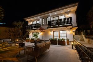 a hotel patio with couches and chairs at night at Villa & Spa Chunarot in Ohrid +91 photos