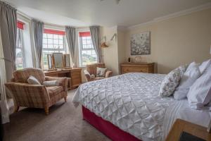 a bedroom with a bed and a desk and chairs at Harmony House Boutique B&B in Stillingfleet