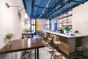 a bar with wooden tables and chairs in a restaurant at DREAM Hotel Lviv in Lviv
