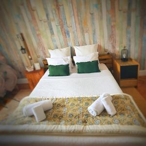 a bedroom with a bed with two towels on it at Alojamentos Vista Mar-Luisa Todi in Setúbal