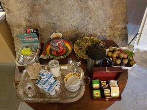 a table with food and other items on it at Chambres d'H&ocirc;tes Aux Tournesols in Malauc&egrave;ne