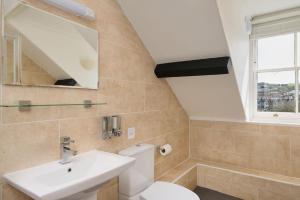 a bathroom with a toilet and a sink at Epchris House in Ilfracombe