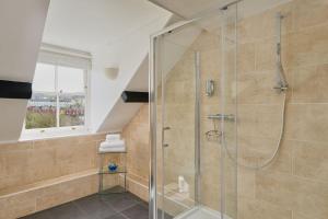 a bathroom with a shower with a glass door at Epchris House in Ilfracombe