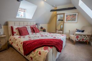 a bedroom with a large bed and a chair at Harmony House Boutique B&B in Stillingfleet