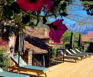 a row of chairs and umbrellas on a deck at Apartamentos Villa de Potes in Potes