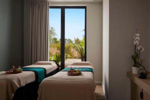 three beds in a room with a window at Tivoli Alvor Algarve - All Inclusive Resort in Alvor