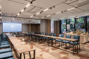 a conference room with tables and chairs and a screen at Doubletree By Hilton Lima San Isidro in Lima