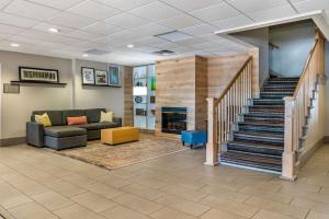 a living room with a couch and a fireplace at Country Inn & Suites by Radisson, Toledo South, OH in Rossford