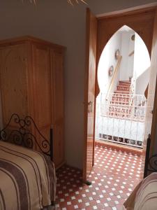 a bedroom with a bed and a room with a staircase at Dar Dada in Safi