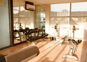 a gym with several treadmills and a large window at Palmy Luxury Beach Phú Quốc in Phu Quoc