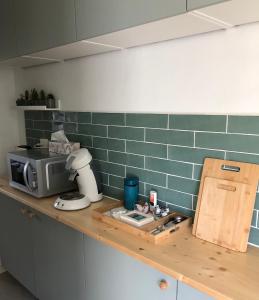 a kitchen with a counter top with a microwave at Oudaen 36 in Lelystad