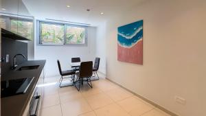a kitchen with a table and chairs in a room at City Napa Seaview Villas - Villa 6 in Ayia Napa