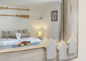 a bedroom with a bed with two swans on it at Fishermans Cottage in Wells next the Sea