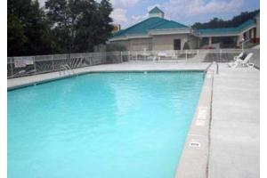 a large blue swimming pool in front of a house at OYO Hotel Harriman in Harriman