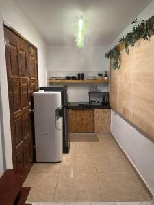 a small kitchen with a refrigerator in a room at House of David - Bungalow at SS2 Petaling Jaya in Petaling Jaya
