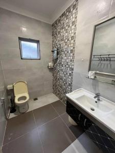 a bathroom with a sink and a toilet and a mirror at House of David - Bungalow at SS2 Petaling Jaya in Petaling Jaya
