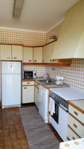 a kitchen with a sink and a stove top oven at Quinta da Lage in Barcelos