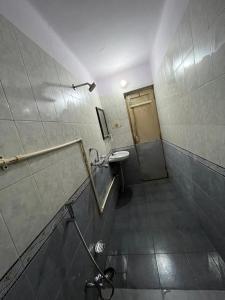 a bathroom with a toilet and a sink and a shower at Vishwa Deva Homestay in Varanasi