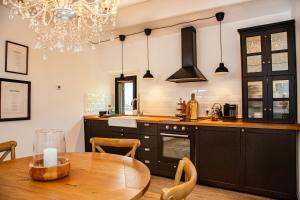 a kitchen with a table and a chandelier at CASA MIA in Cana