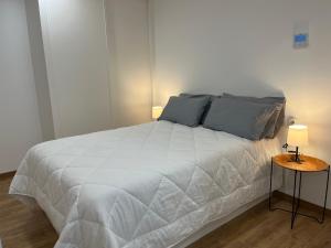 En eller flere senge i et værelse på Apartamento con encanto