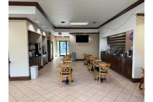 a restaurant with tables and chairs and a kitchen at OYO Hotel Harriman in Harriman