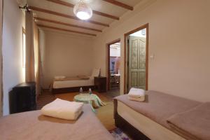 a bedroom with two beds and a table in it at DAR ATLAS CHARME in Imlil