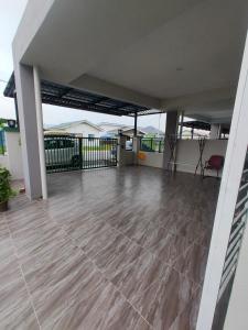 een lege patio met een tafel en een stoel bij Swedish Style Homestay in Teluk Intan
