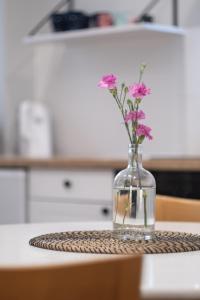 a vase with flowers in it on a table at 29 Gdynia Centrum - Apartament Mieszkanie dla 4 os in Gdynia