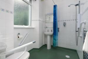 a bathroom with a toilet and a sink and a shower at Epchris House in Ilfracombe