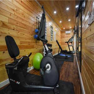 a gym with a treadmill and an exercise ball at Camptel Poconos Lodging in Albrightsville
