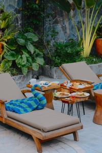 a group of chairs and tables with food on them at Dandaman villa in Yogyakarta