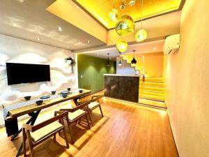 a living room with a desk and a television at 螢居- 3層100坪別墅 心齋橋道頓堀2站 in Osaka