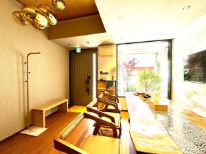 a room with chairs and a long table in a room at 螢居- 3層100坪別墅 心齋橋道頓堀2站 in Osaka