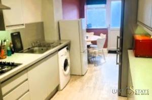 a kitchen with a refrigerator and a sink and a dishwasher at Luke Stays - Welbeck Road in Old Walker