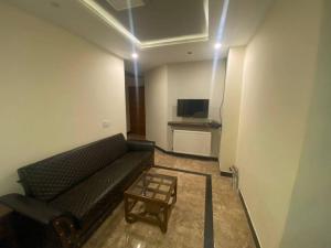 a living room with a couch and a table at AK Hotel & Suites in Murree