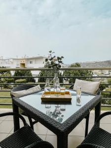 a table with glasses on it on a balcony at by blen.d in Albufeira