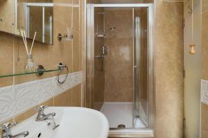 a bathroom with a sink and a shower at Epchris House in Ilfracombe