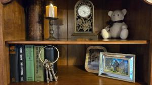 uma prateleira com livros, um relógio e um par de chaves em Moody Salem Home Away From Home em Salem