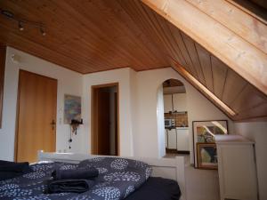 a bedroom with a bed and a wooden ceiling at Ferienwohnung in Weichs in Weichs