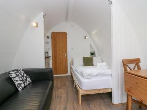 ein Wohnzimmer mit einem Sofa und einem Tisch in der Unterkunft Pod No 19 in Keswick