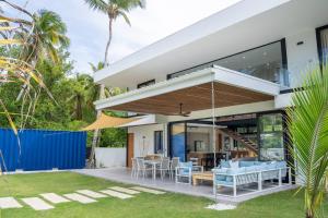 an outdoor patio with blue chairs and a house at Villa Mery - El Portillo Near The Beach in El Limón