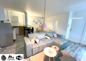 a living room with a couch and a table at Le Grand Saint Aspais - 5 Personnes - in Melun