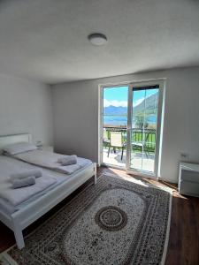 a bedroom with a bed and a view of the ocean at Saraapartman in Plav