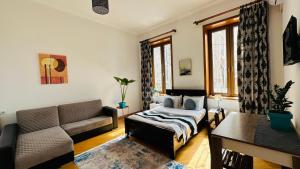 a living room with a couch and a table at Hotel Tamar Mepe in Kutaisi