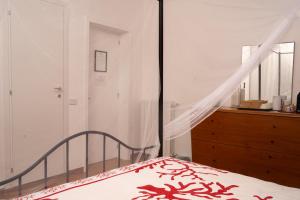 a bedroom with a bed with a red and white bedspread at Casa Vacanze Villa Dan in Impalata