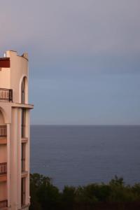 a building with the ocean in the background at Apart Hotel Apolonia Palace in Sinemorets