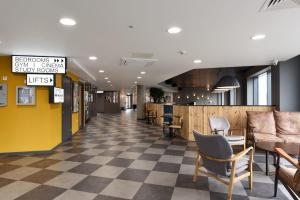 a lobby with a checkered floor and chairs at For Students Only Cosy Ensuite Rooms With Private Bathrooms at Dobbie's Point in Glasgow in Glasgow
