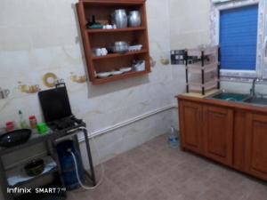 a bathroom with a sink and a tv on a counter at Jerry's hole in Tipaza