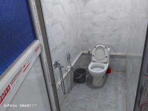 a small bathroom with a toilet in a stall at Jerry's hole in Tipaza